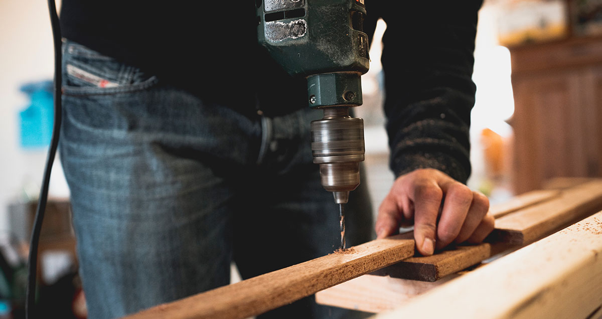 Man drilling wood Man drilling wood